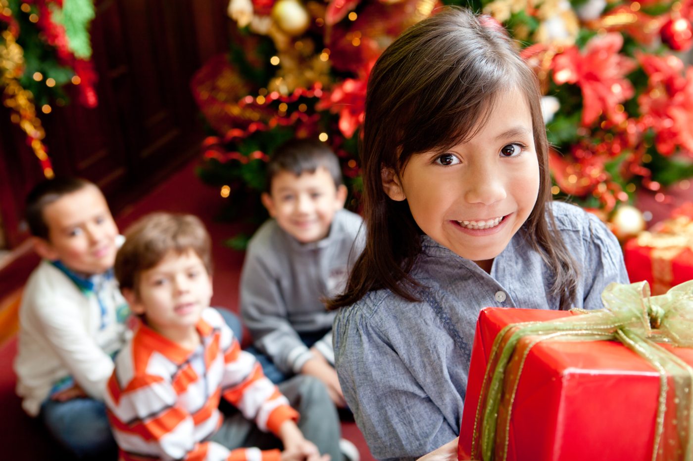 Smiling children with a holiday gift